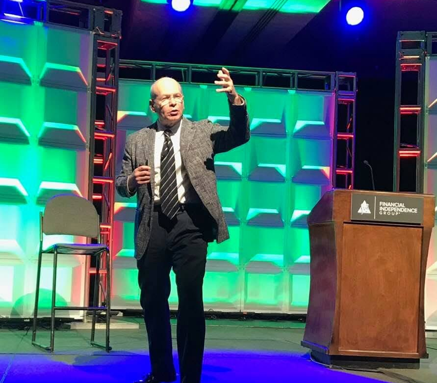 Harley Gordon speaking on stage at an industry conference